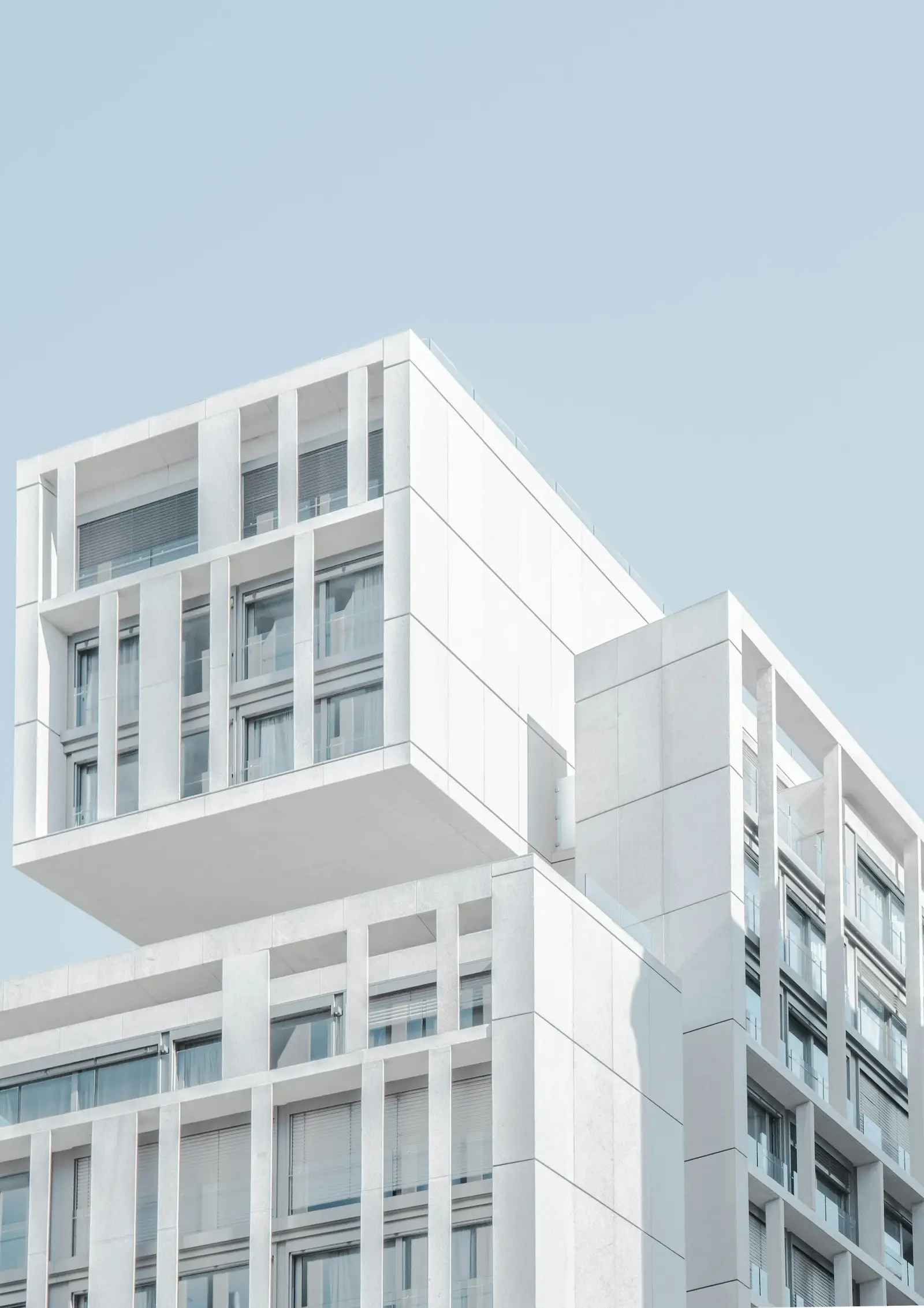 White modern building against a pale blue sky